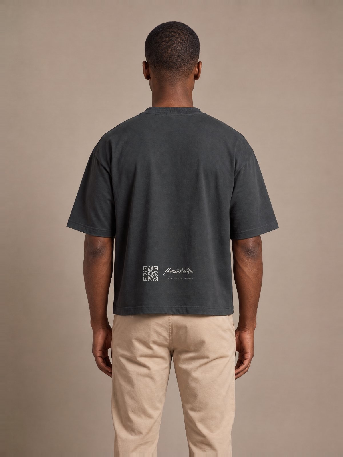 Back of the blank black tee with the Herman Phillips verification mark low on the back