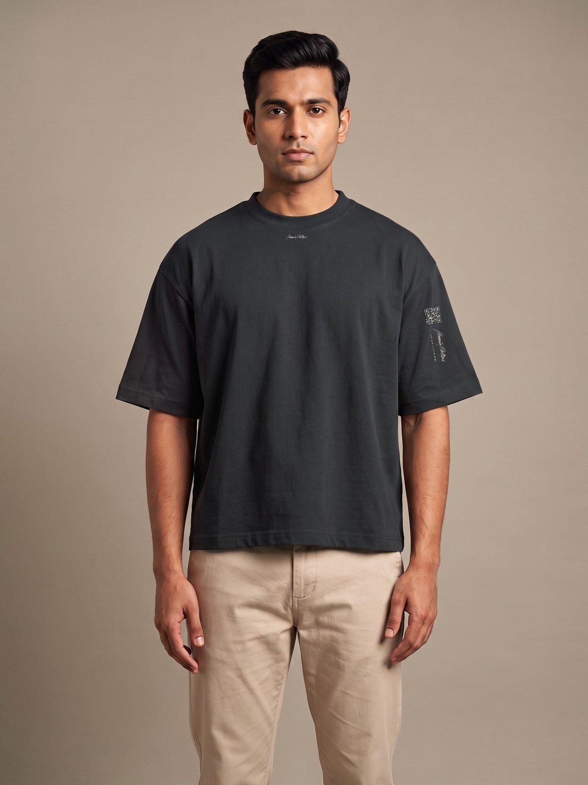 Model wearing the black boxy tee, Herman Phillips script on the chest